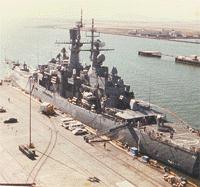 Looking down at a much smaller ship docked at NAS Alameda